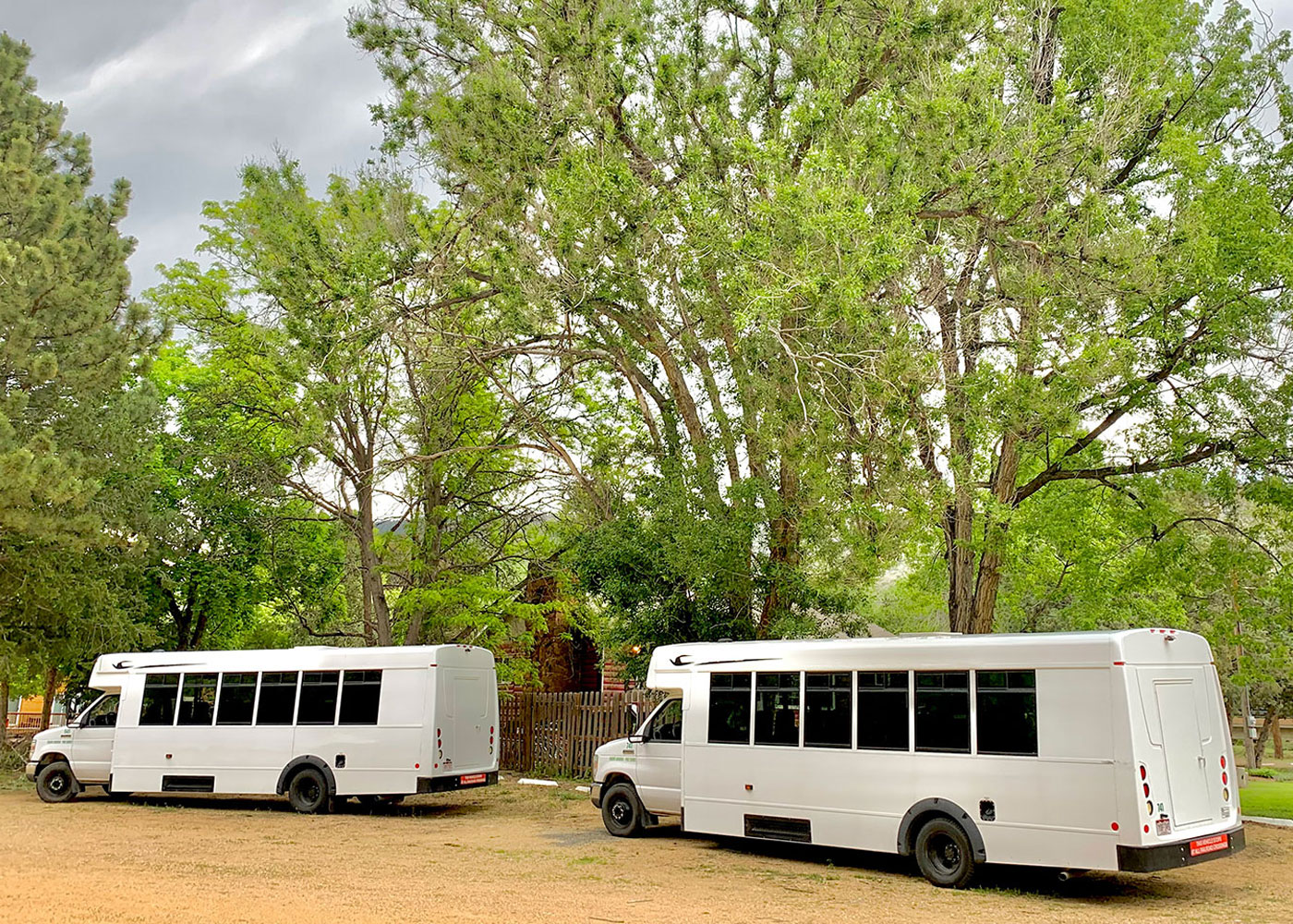 Green Ride Charter Bus white behind the same bus